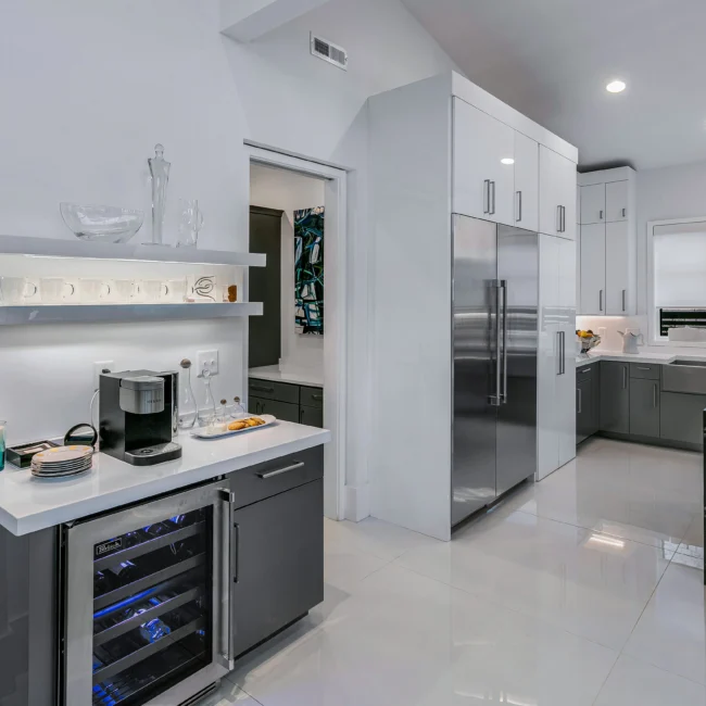 Kitchen beverage station with coffee maker, wine fridge and stainless refrigerator in Urban Oasis by Mike Stevens Homes