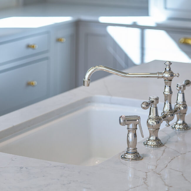 Undermount sink with polished faucet and marble counter in Minimalist French Farmhouse, a custom home by Mike Stevens Homes