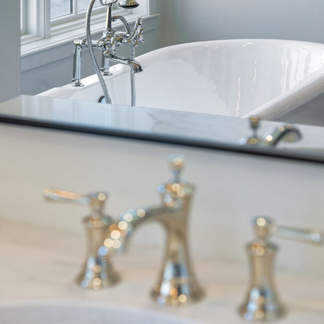 Close-up of brushed-nickel faucet on freestanding tub in Minimalist French Farmhouse, a custom home by Mike Stevens Homes
