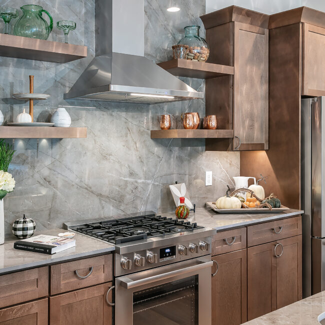 Kitchen range with black oven, wood cabinets and floating shelves in Urban Loft, a custom home by Mike Stevens Homes