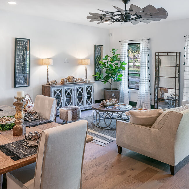 Dining room with wood table, gray sideboard and lantern decor in Urban Loft, a custom home by Mike Stevens Homes