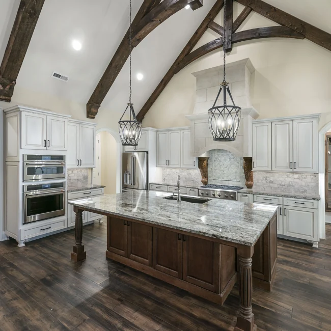 Kitchen with granite island, double ovens and timber vault in European Villa, a custom home by Mike Stevens Homes