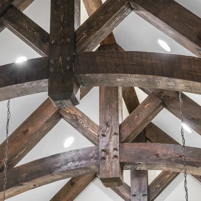 Heavy timber truss ceiling with recessed lights in European Villa, a custom home by Mike Stevens Homes