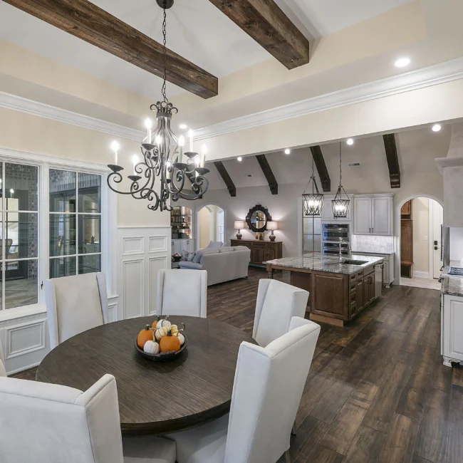 Breakfast nook with round wood table and white chairs in European Villa, a custom home by Mike Stevens Homes