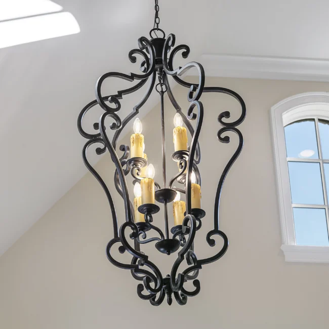 Wrought iron lantern chandelier with candle-style bulbs in European Villa, a custom home by Mike Stevens Homes