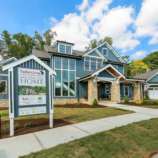 Blue craftsman exterior with stone porch columns in Southern Belle, a custom home by Mike Stevens Homes