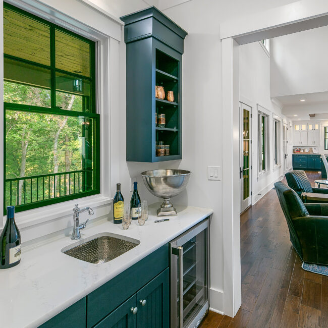 Teal wet bar with quartz counter and under-counter wine fridge in Southern Belle, a custom home by Mike Stevens Homes