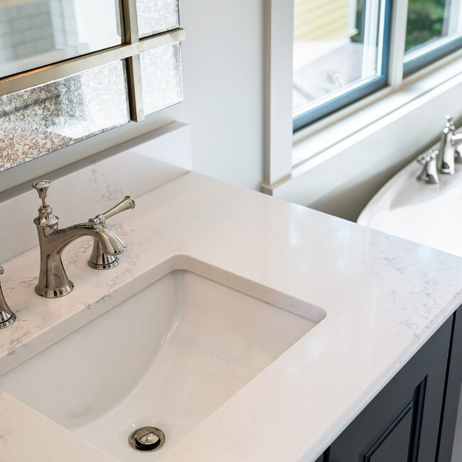 Undermount sink in white quartz vanity with polished chrome faucet in Southern Belle, a custom home by Mike Stevens Homes