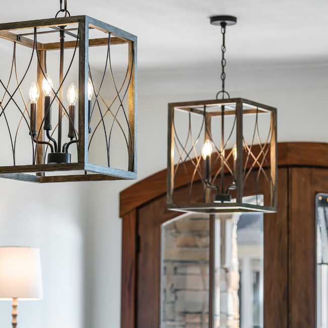 Close-up of black iron lantern pendant over a wood-paneled wall in Southern Belle, a custom home by Mike Stevens Homes