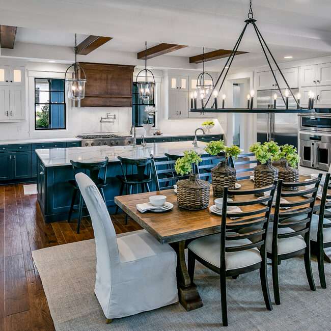 Wood dining table with ladderback chairs and pendant lights in Southern Belle, a custom home by Mike Stevens Homes