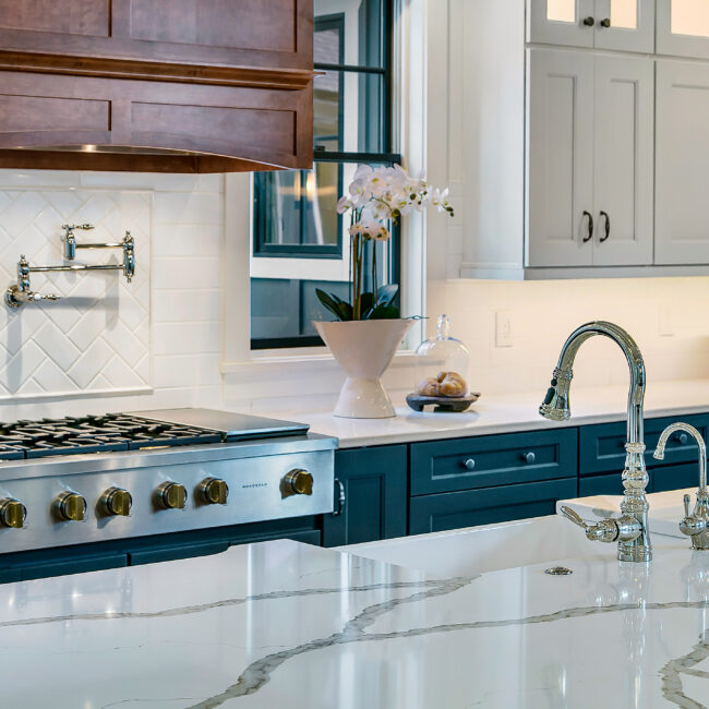 Range with pot filler and marble-look quartz counter in Southern Belle, a custom home by Mike Stevens Homes