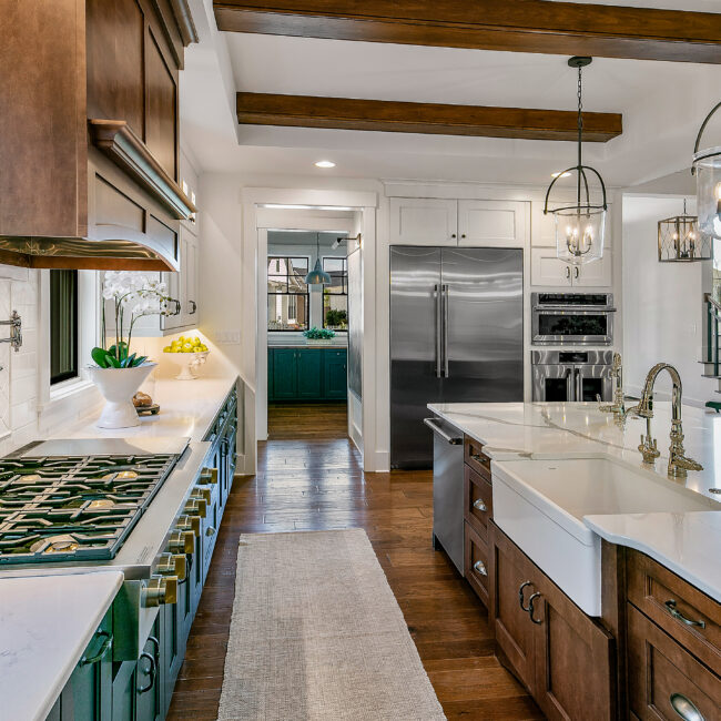 Kitchen island with farmhouse sink and stainless refrigerator in Southern Belle, a custom home by Mike Stevens Homes