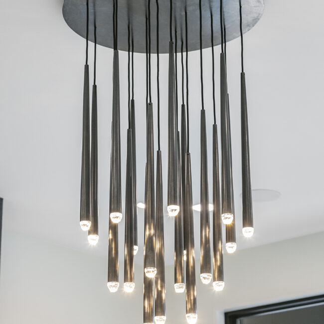 Cluster of tapered black pendant lights in Rocky Top Hideaway, a custom home by Mike Stevens Homes