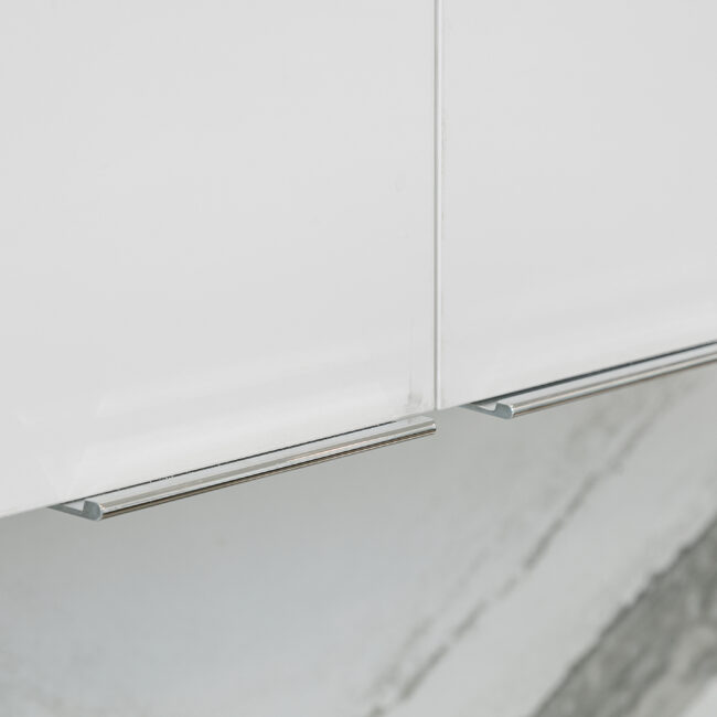 White flat-panel cabinets with brushed nickel pulls in Rocky Top Hideaway, a custom home by Mike Stevens Homes