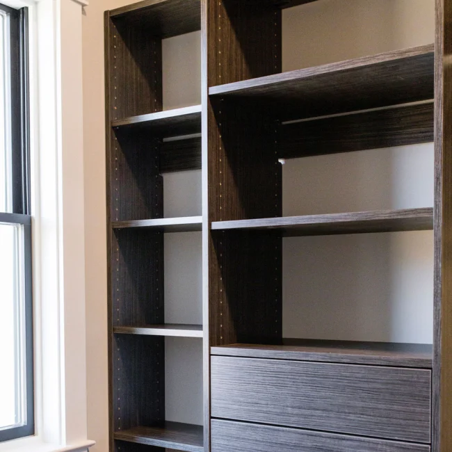 Closet with wood shelving and drawers in Rural Farmhouse, a custom home by Mike Stevens Homes