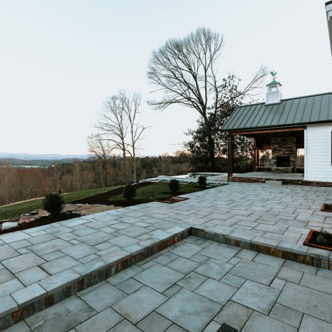 Flagstone terrace with recessed stone planter and covered patio in Mountain Vista by Mike Stevens Homes