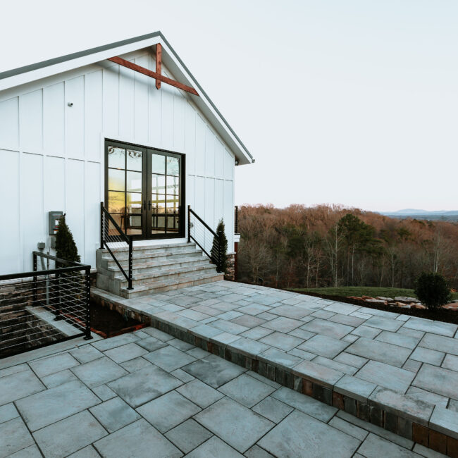 Back entry with French doors, iron railing and wide stone steps in Mountain Vista by Mike Stevens Homes