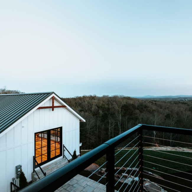 Metal cable-railed deck overlooking wooded valley in Mountain Vista by Mike Stevens Homes