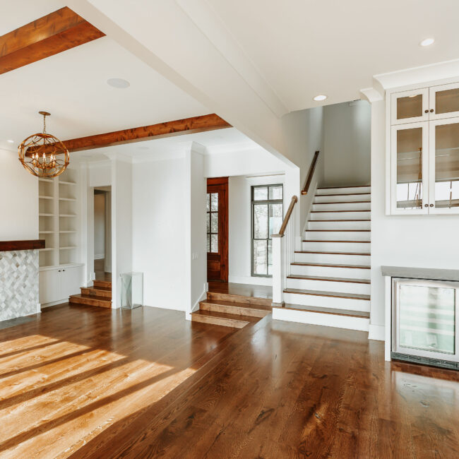 Staircase and wood beams above open living area in Mountain Vista by Mike Stevens Homes