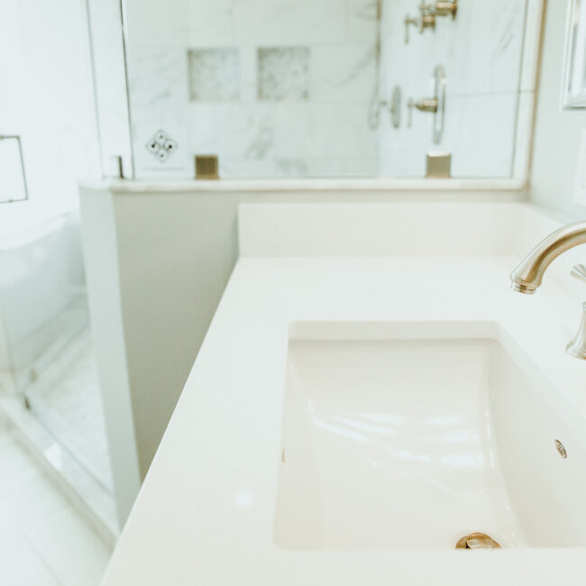 Undermount sink with bathtub faucet and mirror in Timeless Charm, a custom home by Mike Stevens Homes
