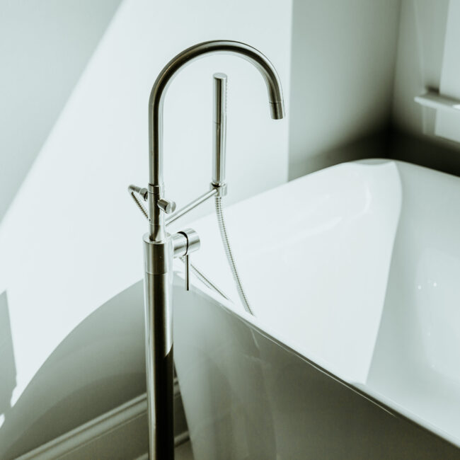 Freestanding tub with tall floor faucet in Timeless Charm, a custom home by Mike Stevens Homes