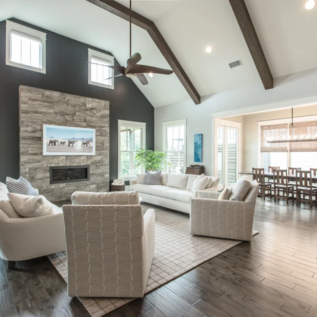 Great room with stone fireplace and tray ceiling in Urban Farmhouse, a custom home by Mike Stevens Homes