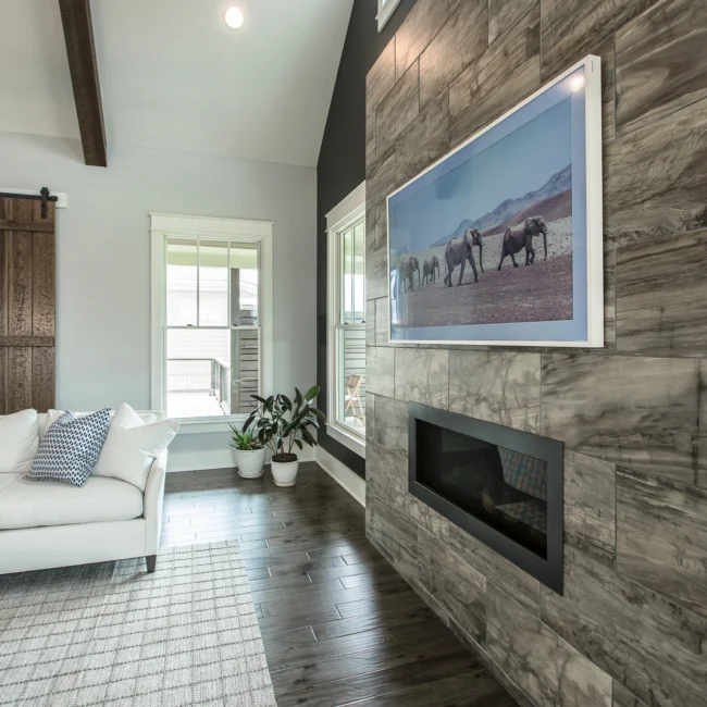 Living room with linear fireplace and horse artwork in Urban Farmhouse, a custom home by Mike Stevens Homes