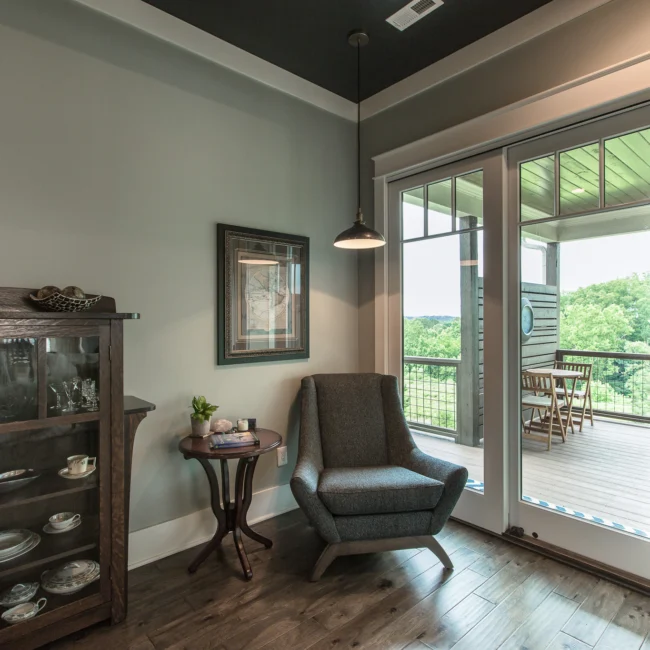 Sitting room with glass cabinet and balcony doors in Urban Farmhouse, a custom home by Mike Stevens Homes