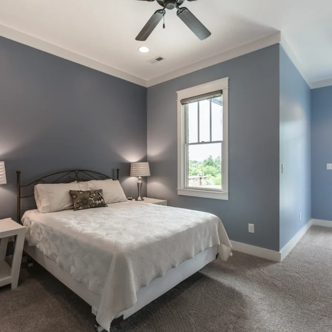 Bedroom with gray walls and window in Urban Farmhouse, a custom home by Mike Stevens Homes