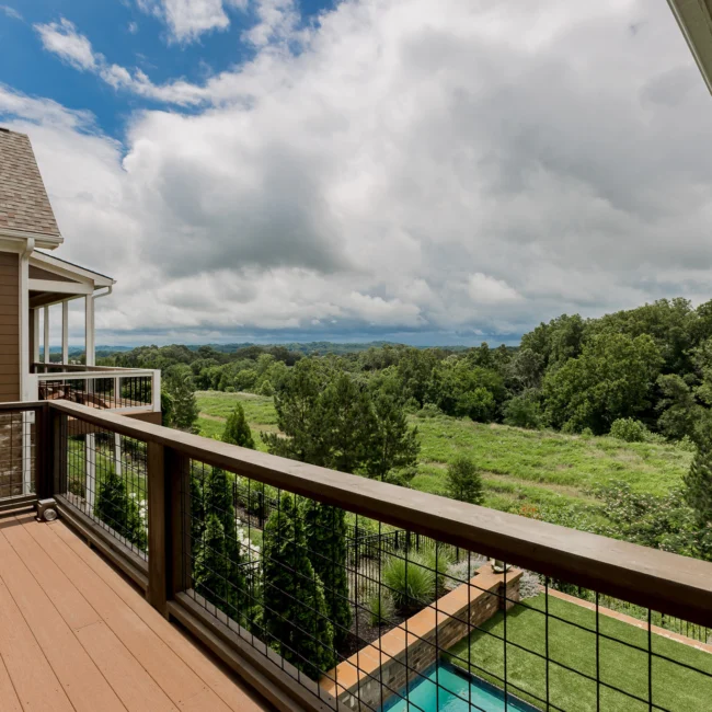 Balcony with cable railing overlooking treeline in Urban Farmhouse, a custom home by Mike Stevens Homes