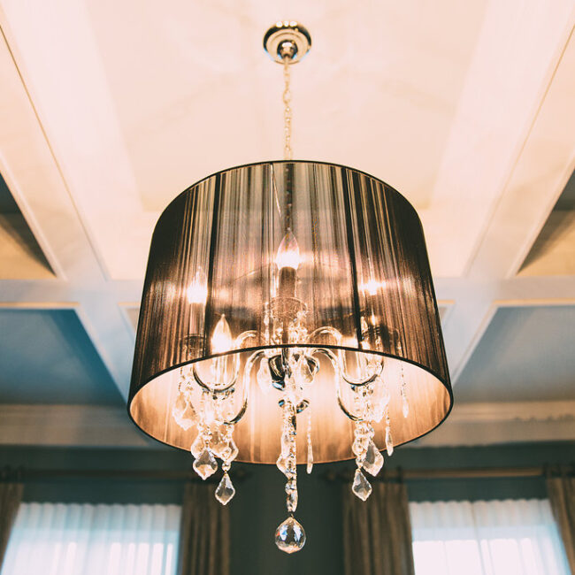 Close-up of drum-shade chandelier with crystal drops in Haunted Mansion Homage, a custom home by Mike Stevens Homes