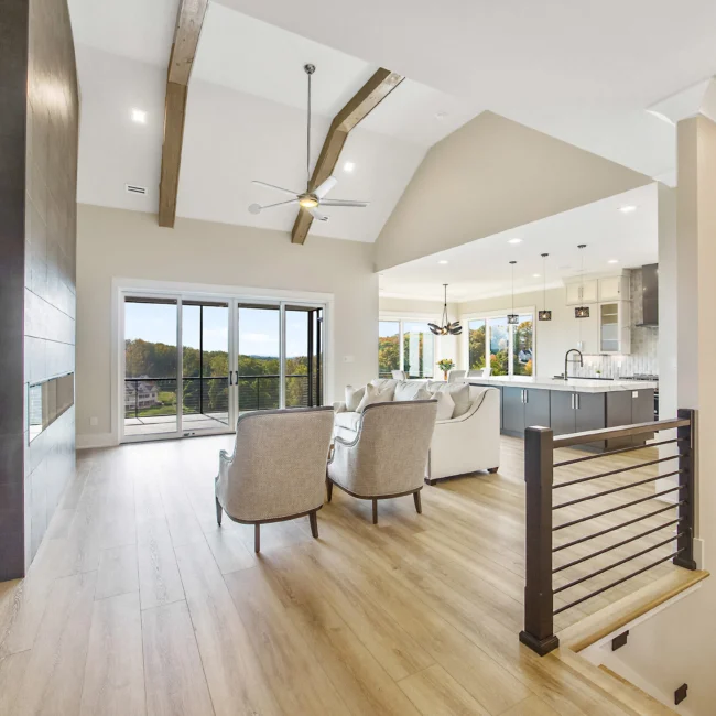 Open living room with metal railing and ceiling fan in Contemporary Luxury, a custom home by Mike Stevens Homes