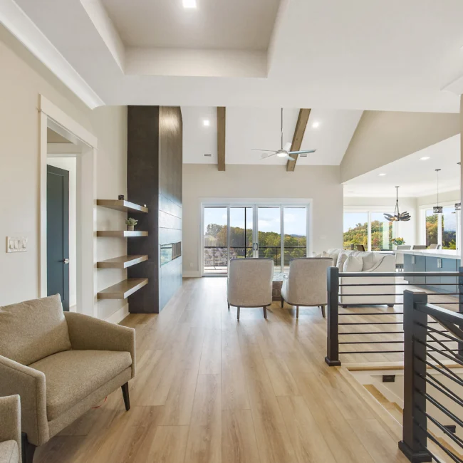 Hallway with floating shelves and open living room in Contemporary Luxury, a custom home by Mike Stevens Homes