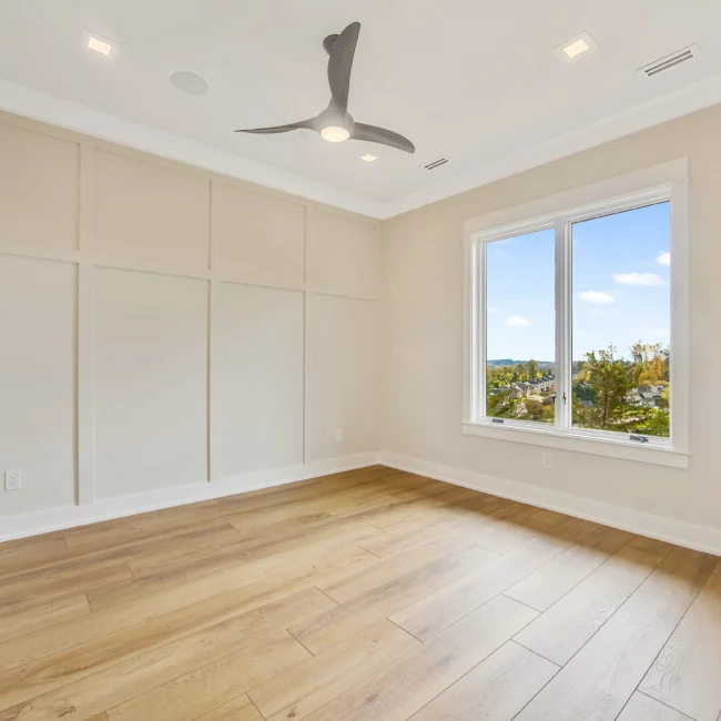 Bedroom with board-and-batten wall and window in Contemporary Luxury, a custom home by Mike Stevens Homes