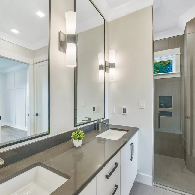 Bath with quartz dual-sink vanity and walk-in shower in Contemporary Luxury, a custom home by Mike Stevens Homes