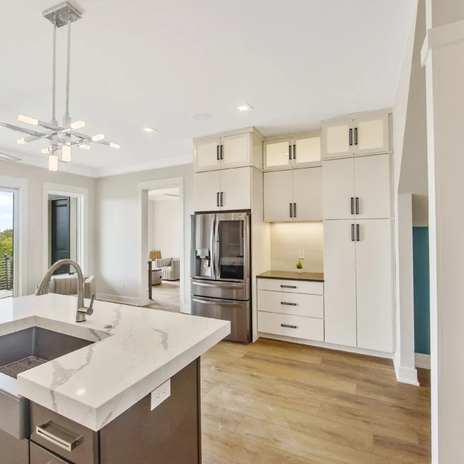 Kitchen with white cabinets and stainless fridge in Contemporary Luxury, a custom home by Mike Stevens Homes