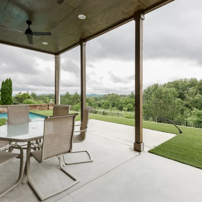 Covered patio with dining table and yard view in Urban Farmhouse, a custom home by Mike Stevens Homes