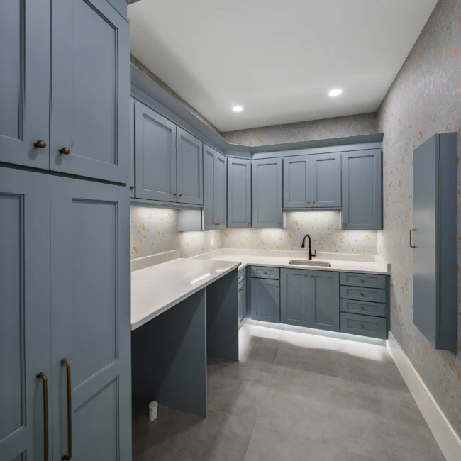 Gray built-in desk and cabinetry with quartz counter in Edgewater Estate, a custom home by Mike Stevens Homes