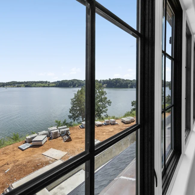 Window view of lake and lakeside construction site in Edgewater Estate, a custom home by Mike Stevens Homes