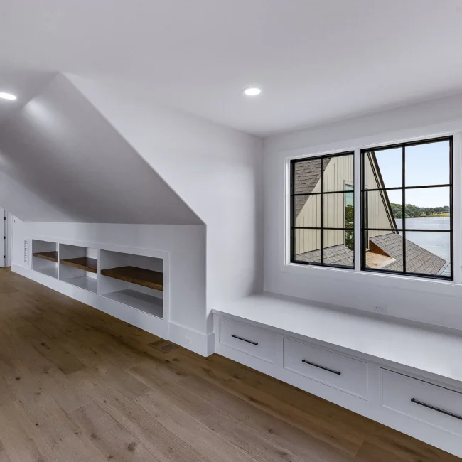 Bonus room with built-in window seat and sloped ceiling in Edgewater Estate, a custom home by Mike Stevens Homes