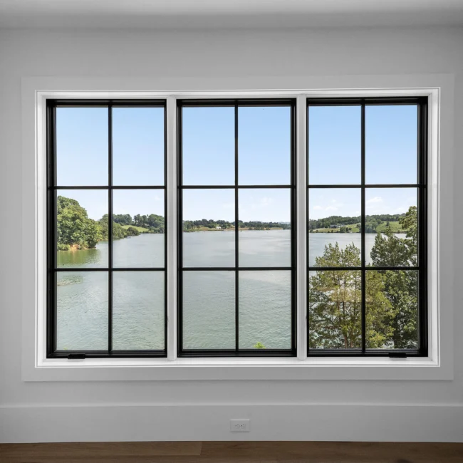 Three-panel black-framed window overlooking the lake in Edgewater Estate, a custom home by Mike Stevens Homes
