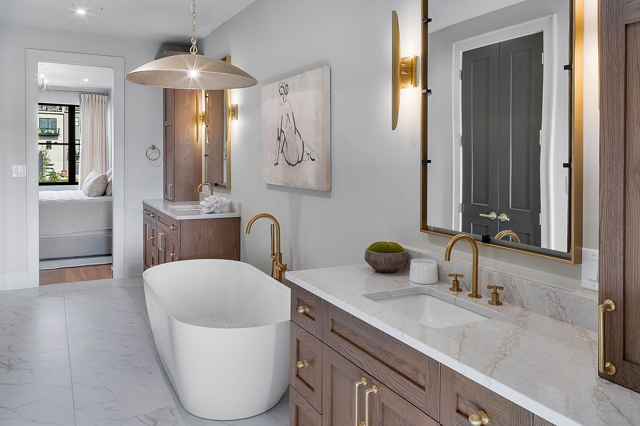 Primary bath with freestanding tub and brass fixtures