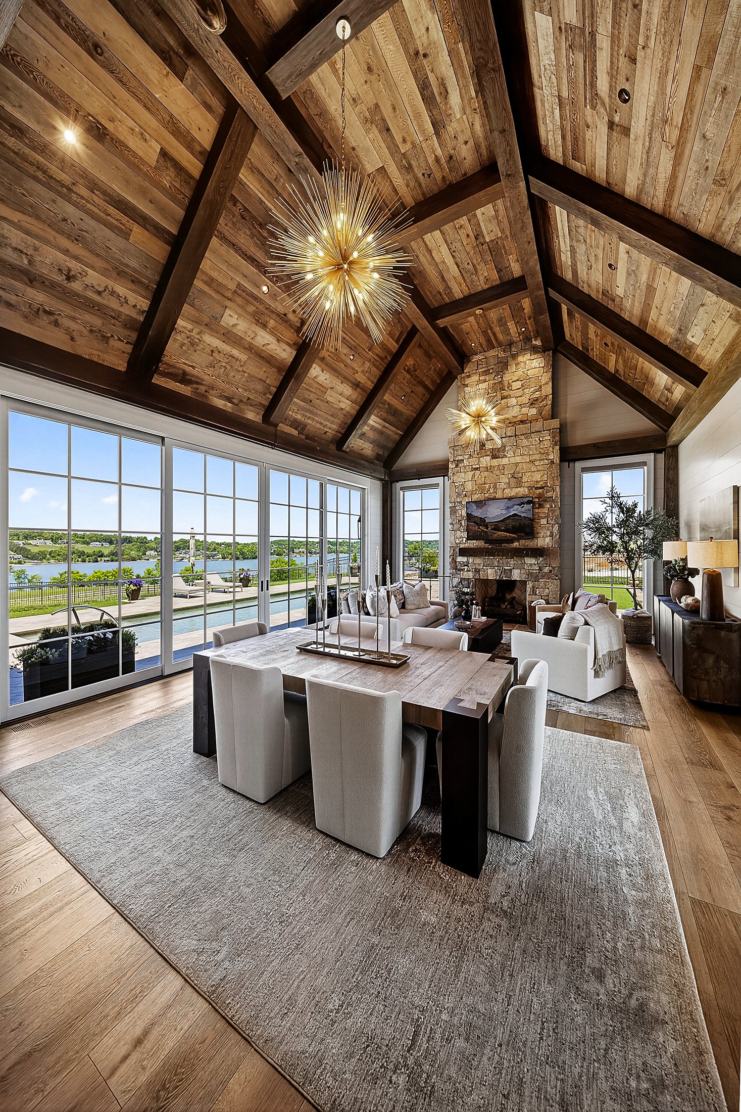 Lakefront dining space with vaulted wood ceiling