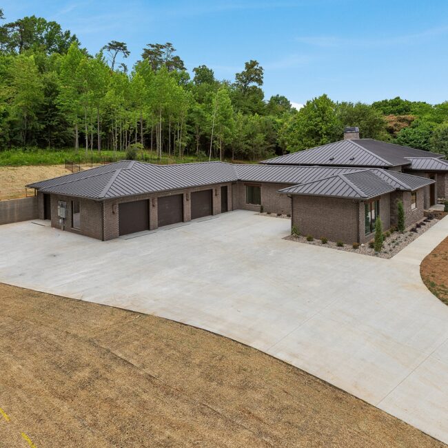 Aerial of Modern Prairie's long low roofline and wooded setting, a custom home by Mike Stevens Homes