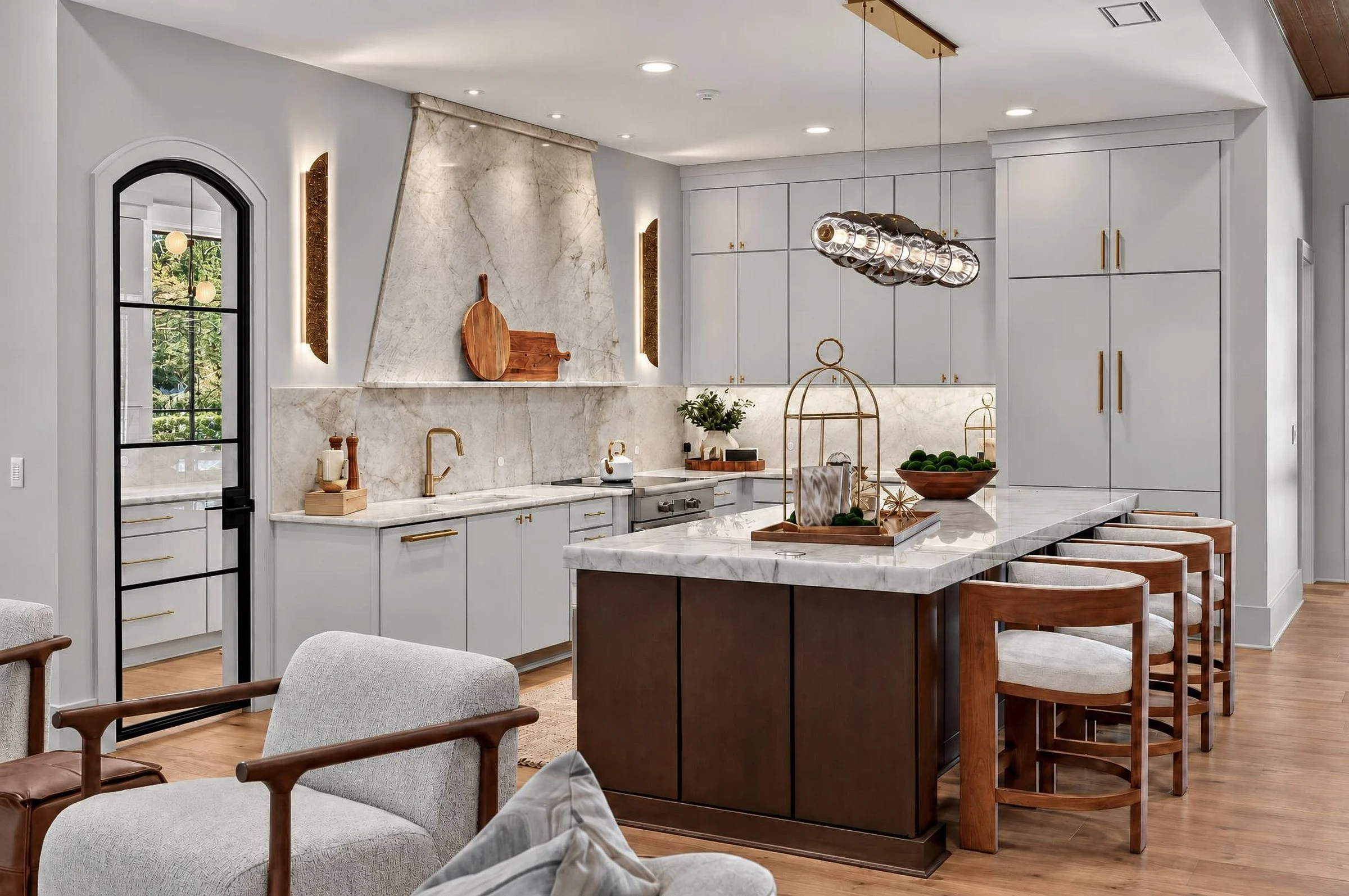 Marble range hood and walnut island in Shino No Mori, a custom home at Tennessee National in Loudon by Mike Stevens Homes