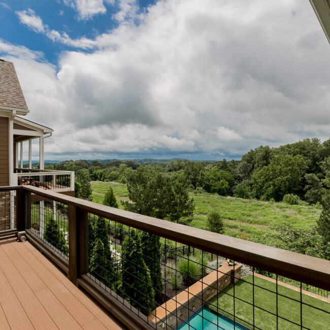 Cable-rail upper porch above the plunge pool at Rockport Gray Farmhouse by Mike Stevens Homes