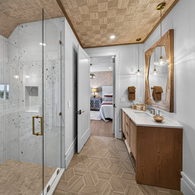 Bathroom with a walk-in glass shower lined in white marble, a woven ceiling, a wood vanity and a herringbone tile floor